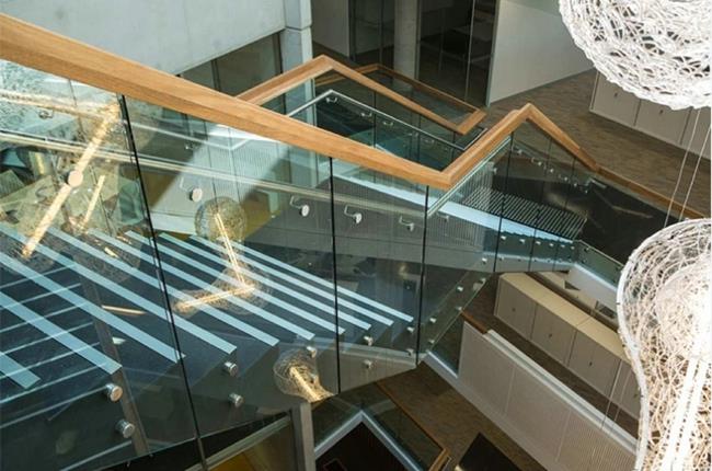 staircase railing with glass standoff